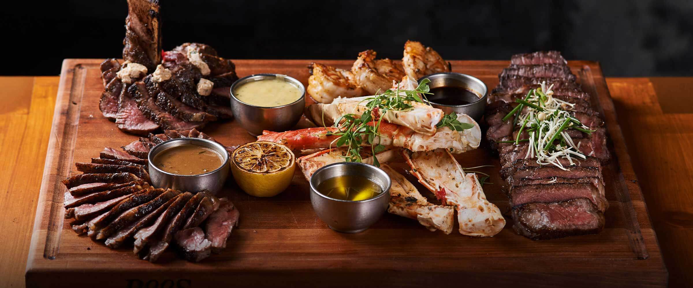 steak and lobster on cutting board - Desktop